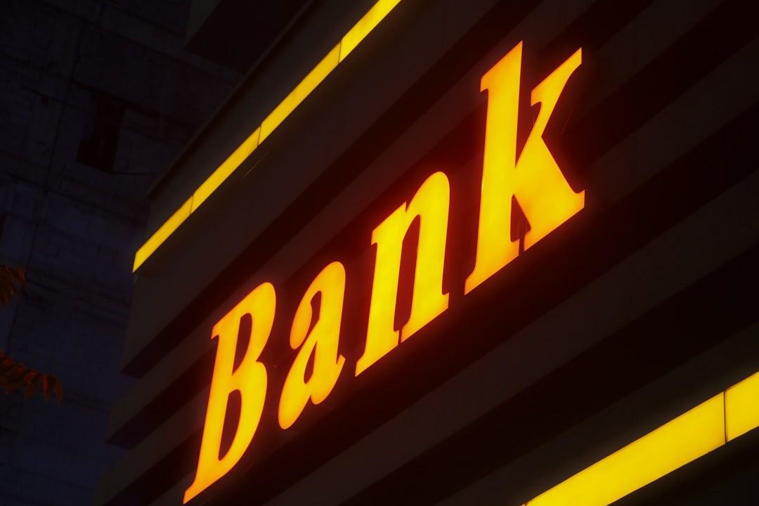 bank building facade a bank sign lit up in the dark