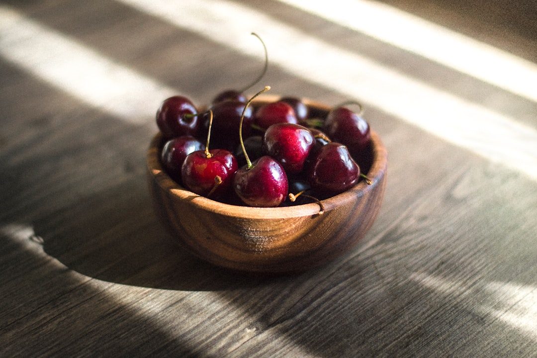 Summer bunch of red cherries in brown bowl